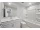 Elegant bathroom with dual sinks, white cabinets, and a modern shower-tub combination at 4113 S 176Th Dr, Goodyear, AZ 85338
