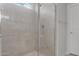 Modern glass-enclosed shower in a bathroom with contemporary tile work and sleek fixtures at 4113 S 176Th Dr, Goodyear, AZ 85338