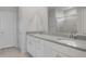 Bathroom featuring double sinks, quartz counters, modern cabinetry, and a glass-enclosed shower at 4113 S 176Th Dr, Goodyear, AZ 85338