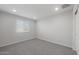Bright bedroom featuring soft carpet, a neutral color scheme, and a sunny window at 4113 S 176Th Dr, Goodyear, AZ 85338