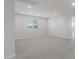 Spacious bonus room with plush carpet, recessed lighting, and a bright window at 4113 S 176Th Dr, Goodyear, AZ 85338