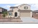 Charming two-story home featuring a tile roof, neutral stucco, and a two-car garage at 4113 S 176Th Dr, Goodyear, AZ 85338
