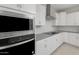 Close-up of a modern kitchen featuring stainless steel appliances, white cabinets and subway tile backsplash at 4113 S 176Th Dr, Goodyear, AZ 85338