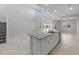 Open concept kitchen with a large island, modern fixtures, and connection to the living space at 4113 S 176Th Dr, Goodyear, AZ 85338