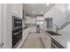 Bright kitchen with stainless steel appliances, modern cabinets and fixtures, and an open layout at 4113 S 176Th Dr, Goodyear, AZ 85338