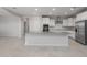 Open-concept kitchen with large center island, stainless steel appliances, and neutral decor at 4113 S 176Th Dr, Goodyear, AZ 85338