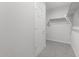 Bright walk-in closet offering ample storage space with shelving and carpeted floor at 4113 S 176Th Dr, Goodyear, AZ 85338