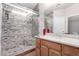 Bathroom with a walk-in shower, mosaic tile, and a single sink vanity at 41580 W Sunland Dr, Maricopa, AZ 85138
