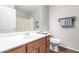 Bathroom features a white sink, wood vanity, toilet, and shower with tub combination at 41580 W Sunland Dr, Maricopa, AZ 85138
