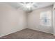 Cozy bedroom features neutral paint, carpet flooring, ceiling fan, and a window at 41580 W Sunland Dr, Maricopa, AZ 85138