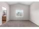 Cozy bedroom with neutral walls, carpet flooring, and a window providing natural light at 41580 W Sunland Dr, Maricopa, AZ 85138
