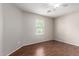 Bright bedroom with wood floors and ample natural light through a window at 41580 W Sunland Dr, Maricopa, AZ 85138