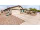 Attractive home showcasing desert landscaping and a convenient two-car attached garage at 41580 W Sunland Dr, Maricopa, AZ 85138