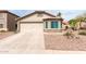 Inviting home with low-maintenance desert landscaping and an attached two-car garage at 41580 W Sunland Dr, Maricopa, AZ 85138