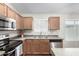 Efficient kitchen layout with stainless steel appliances and ample counter space for cooking prep at 41580 W Sunland Dr, Maricopa, AZ 85138