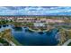 The community aerial displays a tranquil lake, a pool, and a clubhouse, offering a picturesque and active lifestyle at 4364 S Tatum Ln, Gilbert, AZ 85297