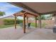 Backyard patio with brick pavers, a pergola, and a dining table creates a charming outdoor seating area at 4364 S Tatum Ln, Gilbert, AZ 85297