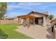 Backyard featuring a brick patio, a covered pergola, and a well-maintained yard, creating an inviting outdoor space at 4364 S Tatum Ln, Gilbert, AZ 85297