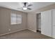 Neutral bedroom featuring a ceiling fan, window with blinds, and a closet with sliding doors at 4364 S Tatum Ln, Gilbert, AZ 85297