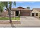 Tan single-story home with a brown roof, a two-car garage, and grassy front lawn at 4364 S Tatum Ln, Gilbert, AZ 85297