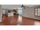 Open floor plan boasts wood floors, a modern ceiling fan, and natural light from a window with custom wood shutters at 4364 S Tatum Ln, Gilbert, AZ 85297