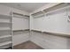 Walk-in closet with shelving units and wood poles for hanging clothes at 4364 S Tatum Ln, Gilbert, AZ 85297