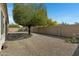 Spacious backyard with mature trees, gravel ground cover and block wall fence providing privacy at 4417 N 156Th Dr, Goodyear, AZ 85395