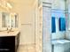 Bright bathroom featuring a shower, double sink, and sleek finishes, with built in shelving at 4417 N 156Th Dr, Goodyear, AZ 85395