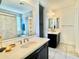 Bathroom with a double vanity, tiled shower, and a built-in shelving unit at 4417 N 156Th Dr, Goodyear, AZ 85395