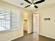 Bedroom with tile floors and ceiling fan showing closet and access to other rooms at 4417 N 156Th Dr, Goodyear, AZ 85395