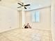 Spacious bedroom with neutral walls, tile floor, and a ceiling fan at 4417 N 156Th Dr, Goodyear, AZ 85395