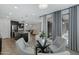 Open-concept dining area with modern furnishings, leading into kitchen and living spaces at 4417 N 156Th Dr, Goodyear, AZ 85395