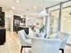 Bright dining area with a glass table, upholstered chairs, and sliding glass doors for outdoor access at 4417 N 156Th Dr, Goodyear, AZ 85395
