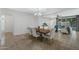 Elegant dining room with a wooden table, upholstered chairs, and stylish chandelier at 4417 N 156Th Dr, Goodyear, AZ 85395