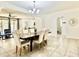 Spacious dining room with elegant chandelier and stylish furnishings, seamlessly flowing into the living area and kitchen at 4417 N 156Th Dr, Goodyear, AZ 85395