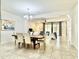 Bright dining room featuring a chandelier, large table with seating for six, and an open-concept layout at 4417 N 156Th Dr, Goodyear, AZ 85395