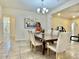 Well-lit dining area showcasing a wooden table, neutral chairs, and open flow to other living spaces at 4417 N 156Th Dr, Goodyear, AZ 85395
