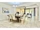 Open-concept dining area with a wooden table, comfortable seating and adjacent living space at 4417 N 156Th Dr, Goodyear, AZ 85395