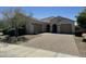 Charming single-story home featuring a tile roof, stucco siding, and a spacious three-car garage at 4417 N 156Th Dr, Goodyear, AZ 85395