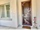 Charming home entryway with a unique desert-themed security door and desert themed decor at 4417 N 156Th Dr, Goodyear, AZ 85395