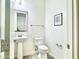 Clean half bathroom with pedestal sink, framed mirror, and modern fixtures at 4417 N 156Th Dr, Goodyear, AZ 85395