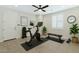 Well-equipped home gym with exercise bike, weights, bench, and bright natural light at 4417 N 156Th Dr, Goodyear, AZ 85395