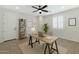 Bright home office featuring a modern desk, stylish shelving, and a comfortable workspace at 4417 N 156Th Dr, Goodyear, AZ 85395