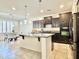Gourmet kitchen featuring dark cabinetry, granite countertops, and a large island, perfect for entertaining at 4417 N 156Th Dr, Goodyear, AZ 85395