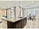 Modern kitchen island with granite countertops and views to the breakfast nook and living area at 4417 N 156Th Dr, Goodyear, AZ 85395