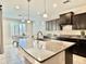 Well-lit kitchen with granite counters, dark wood cabinets, stainless appliances, and eat-in nook at 4417 N 156Th Dr, Goodyear, AZ 85395