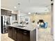 Modern kitchen featuring stainless steel appliances, granite countertops, and an open floorplan at 4417 N 156Th Dr, Goodyear, AZ 85395