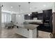 Modern kitchen features granite countertops, black cabinetry, and stainless steel appliances at 4417 N 156Th Dr, Goodyear, AZ 85395