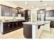 Well-appointed kitchen with granite countertops, dark wood cabinetry, and an island, offering both style and functionality at 4417 N 156Th Dr, Goodyear, AZ 85395