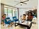 Bright and airy living room with sliding doors, a ceiling fan, and views to the kitchen at 4417 N 156Th Dr, Goodyear, AZ 85395